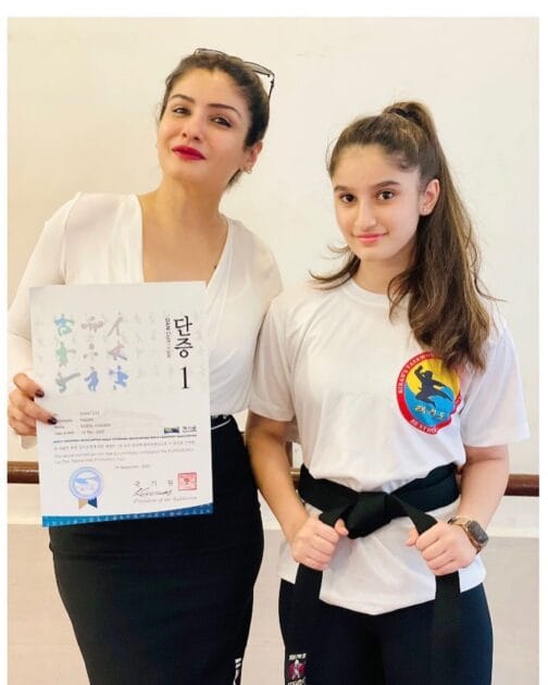 Rasha with her black belt in taekwondo and her mother Raveena